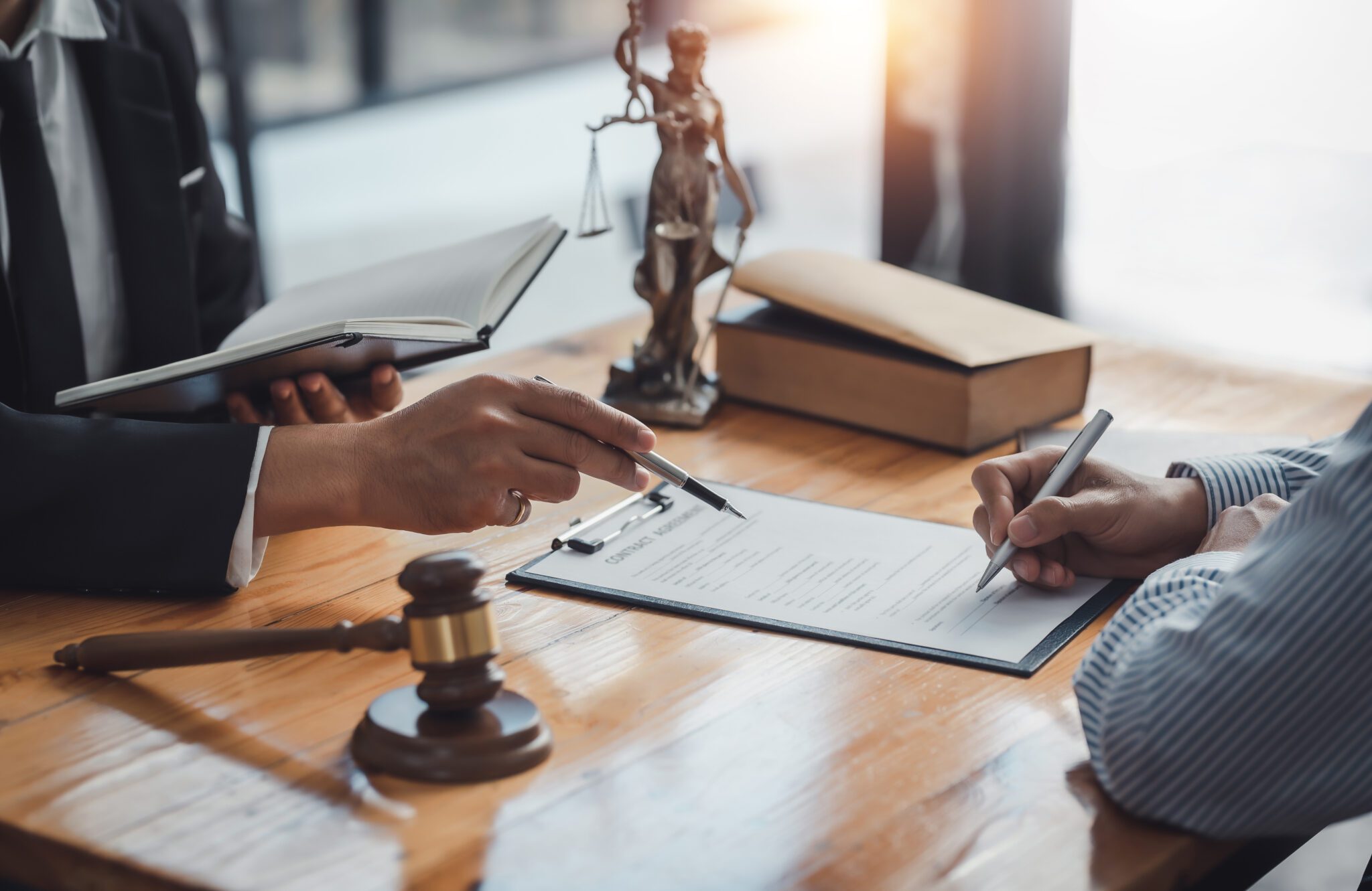 Sign the agreement The Concept of Legal Procedure and Litigation. Legal consultation with documents and gavel.
